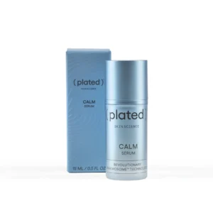 A silver bottle of Plated Skin Science Calm Serum sits beside its light blue box, both showing the product name. Pair the serum with the Detoxifying Mask for a revitalizing skincare routine.