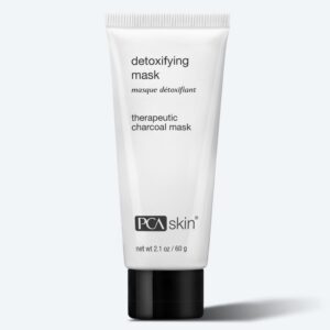 A white tube of PCA Skin Detoxifying Mask (2.1 oz/60 g) with a black cap is labeled "therapeutic charcoal mask" and shown against a light gray background.