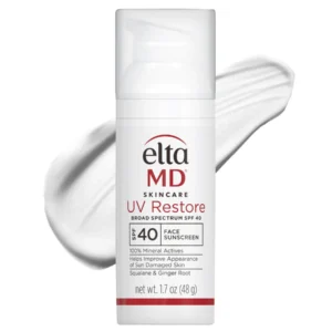 A bottle of EltaMD Skincare UV Restore Broad Spectrum SPF 40 Face Sunscreen, 1.7 oz, is shown in front of a smear of white sunscreen cream. The label highlights squalane and ginger root for skin improvement.
