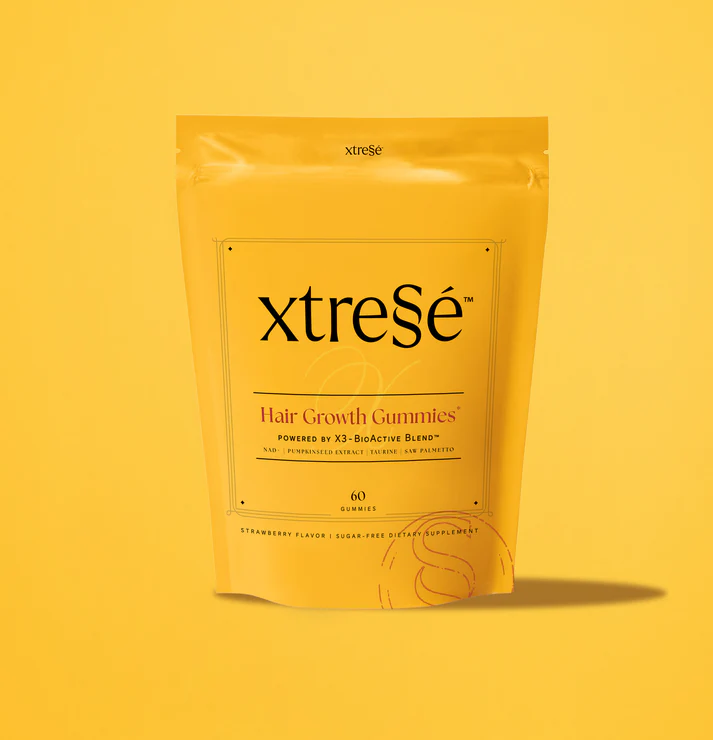 A yellow pouch labeled xtresé Hair Growth Gummies stands upright on a yellow background, containing 60 strawberry-flavored, sugar-free gummies for hair growth. Next to it is the Detoxifying Mask for a complete beauty routine.