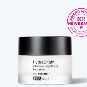 A jar of Detoxifying Mask with a black lid sits beside a pink 2025 NewBeauty Award Winner seal. Its light gray backdrop highlights this skincare essential—perfect to pair with your favorite hydrating cream.