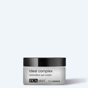 A small white jar with a black lid labeled "ideal complex restorative eye cream" by PCA Skin sits against a plain light background—perfect to pair with the Detoxifying Mask for refreshed, radiant skin.