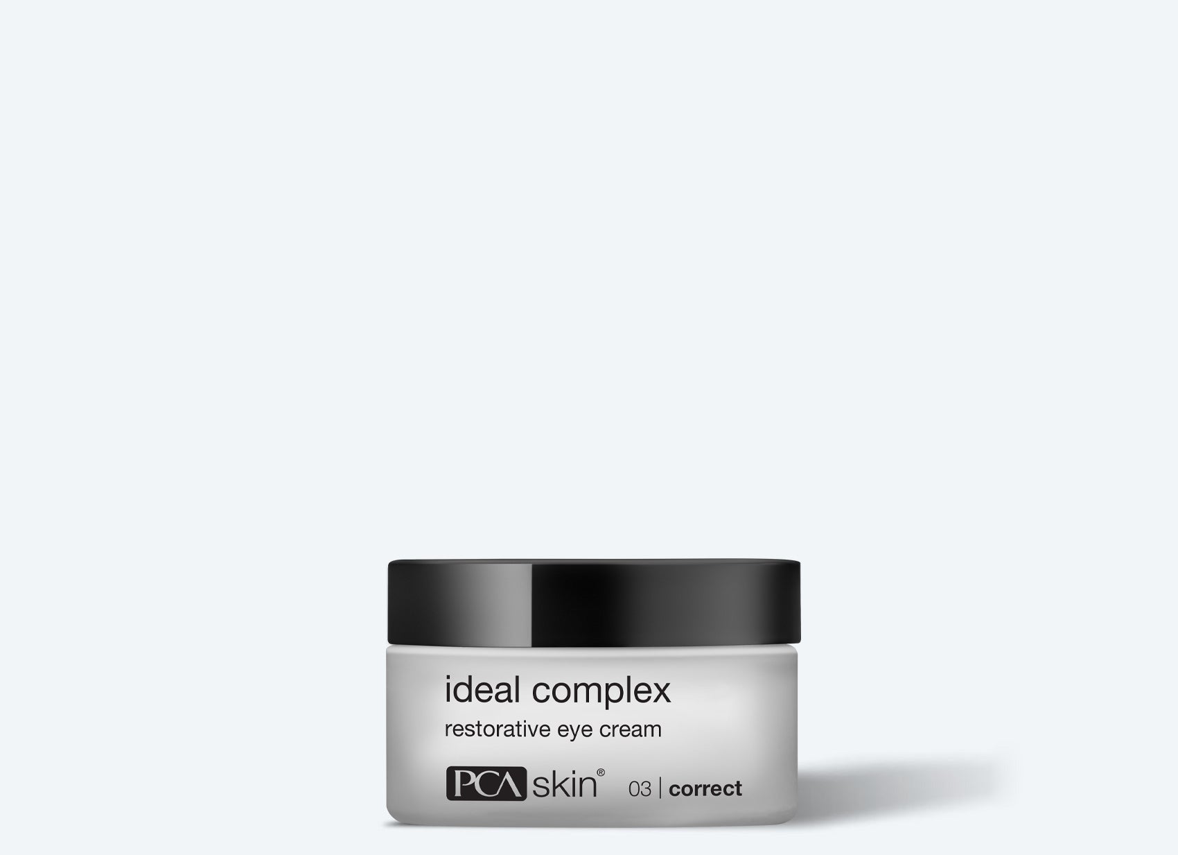 A small white jar with a black lid labeled "ideal complex restorative eye cream" by PCA Skin sits against a plain light background—perfect to pair with the Detoxifying Mask for refreshed, radiant skin.