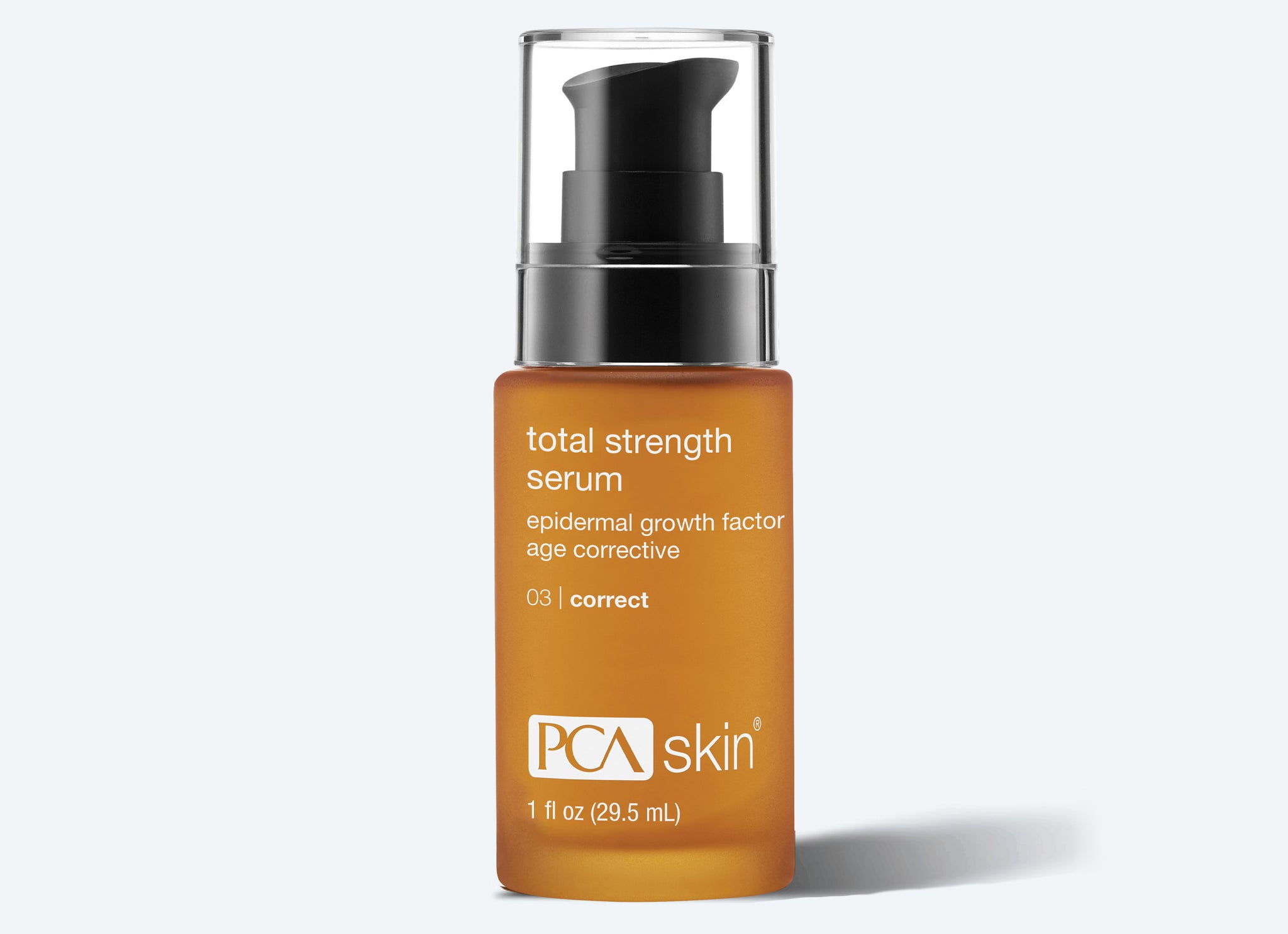 A brown glass bottle of PCA Skin Total Strength Serum with a black pump dispenser and white text, labeled as an age corrective epidermal growth factor serum, is shown next to a Detoxifying Mask against a light background.